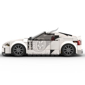 May include: A white sports car model made of interlocking blocks. The car features black wheels, a sleek design, and a logo on the side. The model has a spoiler and a tinted windshield. The car is set against a white background.