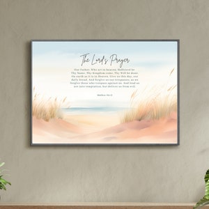 May include: A printable wall art design featuring a watercolour painting of a beach scene with tall grasses and a blue sky. The text "The Lord's Prayer" is printed in black at the top of the image, followed by the text of the prayer in black.