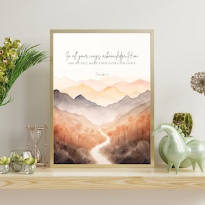May include: A watercolour painting of a mountain range with a river flowing through it. The painting features a quote from Proverbs 3:6, "In all your ways acknowledge Him, and He will make your paths straight."