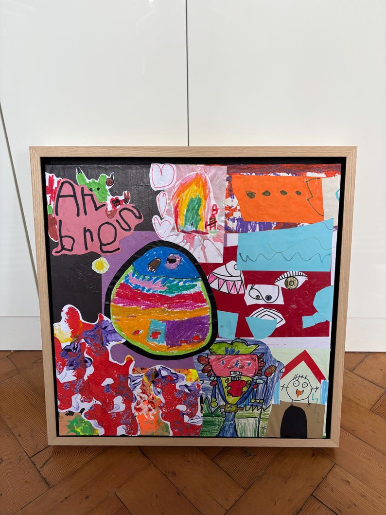 May include: A framed collage artwork featuring a vibrant mix of children's drawings, including a large colorful oval, abstract red shapes, a figure with a hat, and a house. The text "Ah bren" is written in black marker on the left side of the piece.