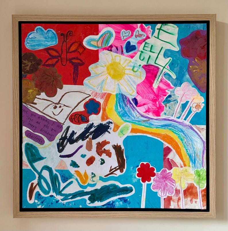 May include: A framed mixed-media artwork featuring a vibrant collage of children's drawings and paintings. The composition includes a rainbow, a yellow sun, flowers, a butterfly, and clouds in various colors. Handwritten text reads: Love you mommy. I love you and give you my happy birthday. Charlotte.