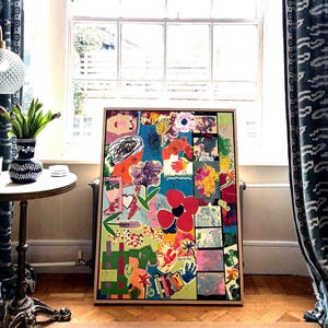May include: A rectangular framed artwork featuring a vibrant collage of colorful abstract shapes, floral motifs, handprints, and whimsical illustrations in shades of red, blue, green, yellow, and pink, set against a bright turquoise background.