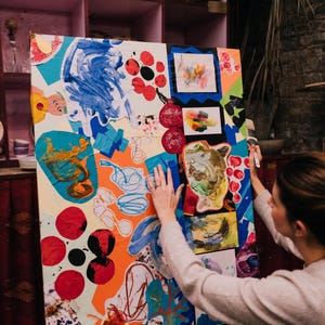 May include: A large rectangular canvas featuring a vibrant collage of abstract shapes, painted textures, and layered paper cutouts in bright shades of blue, orange, red, and green. The artwork displays various hand-drawn scribbles and patterns.