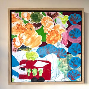May include: A framed mixed-media collage featuring a red bus cutout with the name Charlie printed on it, surrounded by abstract orange paint blobs, green shapes, and a vertical column of blue handprint cutouts on a white and dark red background.