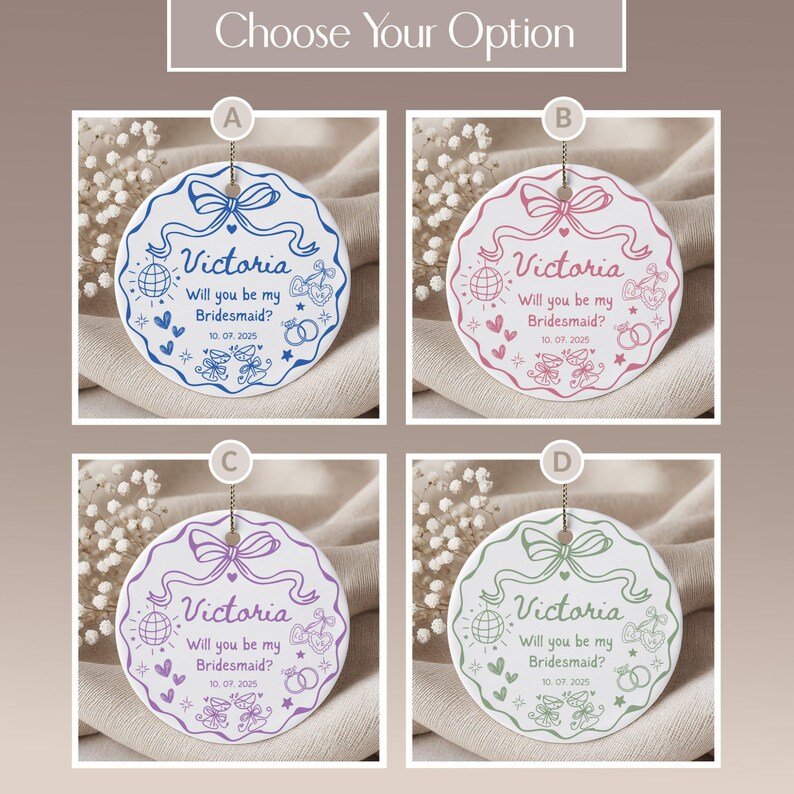 May include: Four round bridesmaid proposal ornaments in blue, pink, purple, and green. Each ornament features a bow, the name "Victoria", and the text "Will you be my Bridesmaid?" with the date 10.07.2025.