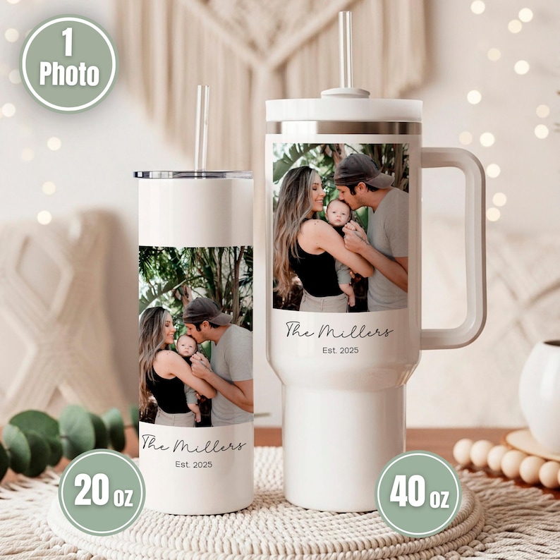 May include: Two white stainless steel tumblers with lids and straws. The 20 oz tumbler and 40 oz handled tumbler both feature a custom photo of a family, the text The Millers, and Est. 2025 printed on the front surface of each container.