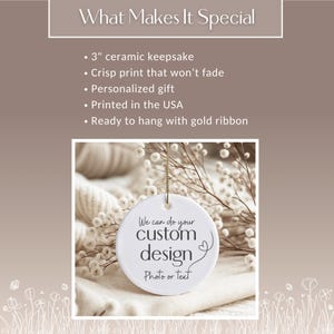 May include: A white ceramic keepsake with the text "We can do your custom design Photo or text". The ornament is 3 inches in diameter and has a gold ribbon for hanging. The background includes dried flowers and a soft, white fabric.