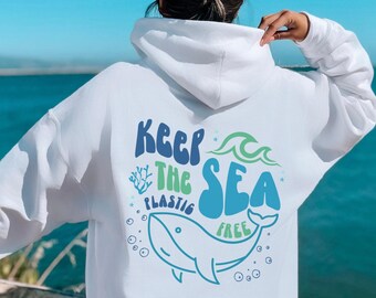 May include: White hoodie with a blue whale graphic and the text "Keep the Sea Plastic Free" on the back.