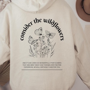 Betrachten Sie die Wildflowers Hoodie Übergroße Sweatshirt für Frauen Glaube basiert Bekleidung Boho Grafik Sweatshirt Matthäus Bibel Vers Hoodie
