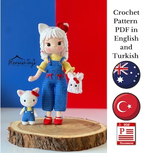 Può includere: Schema a uncinetto in PDF in inglese e turco per una bambola carina con un cappello bianco e rosso e un vestito a salopette blu. La bambola tiene una piccola borsa bianca con un viso di gatto. Lo schema è disponibile sia in inglese che in turco.