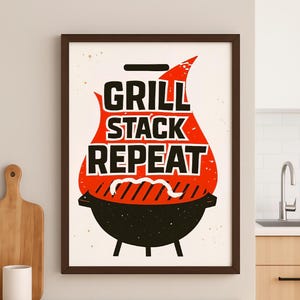 May include: A framed print with the words "GRILL STACK REPEAT" in bold black letters, set against a red flame-shaped background. The design includes a black grill illustration at the bottom, perfect for kitchen or dining room decor.