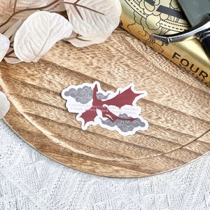 May include: A red dragon sticker with a quote that reads "A dragon without its rider is a tragedy, a rider without their dragon is dead."