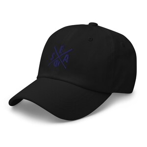May include: A black baseball cap with a navy blue embroidered logo featuring crossed baseball bats and a baseball with the letters "SEA" inside.