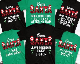 May include: A collection of black and green short-sleeve t-shirts featuring the text Dear Santa in red and black buffalo plaid lettering with Santa hat accents. Each shirt displays unique holiday-themed phrases including My Husband Did It.