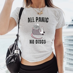 May include: Gray t-shirt with a graphic of a possum holding a disco ball. The text "All Panic No Disco" is printed on the shirt.