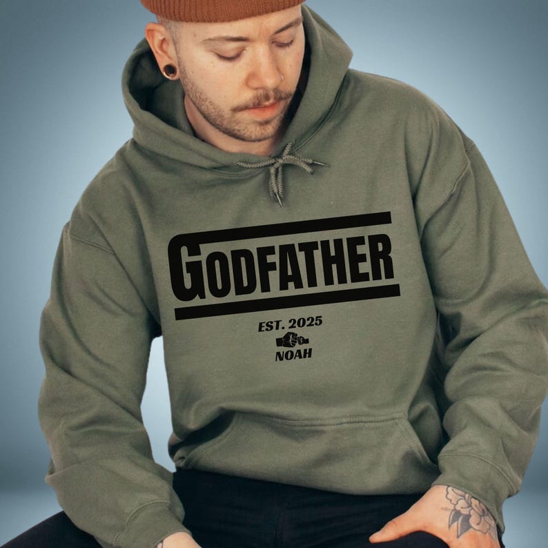 May include: A green hooded sweatshirt with the text "GODFATHER EST. 2025 NOAH" printed on the front.