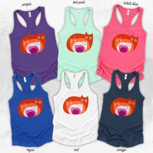 May include: A collection of six racerback tank tops in various colors: purple, hot pink, tahiti blue, royal blue, red, and indigo. Each tank top features a graphic of three stylized cats in shades of orange, pink, and white.