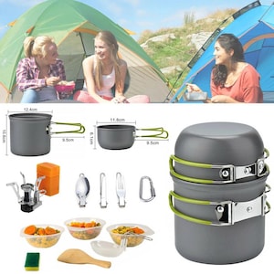 May include: A camping cookware set including two gray pots with green folding handles, a portable stove, a spoon, a fork, a knife, a carabiner, three plastic bowls with food, a sponge, and a wooden spatula. Dimensions are 12.4cm by 10.6cm and 11.6cm by 6.1cm.