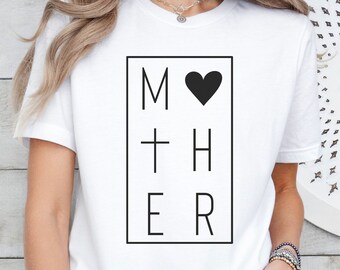 May include: White t-shirt with a black graphic that says "MOTHER" with a heart replacing the "O".