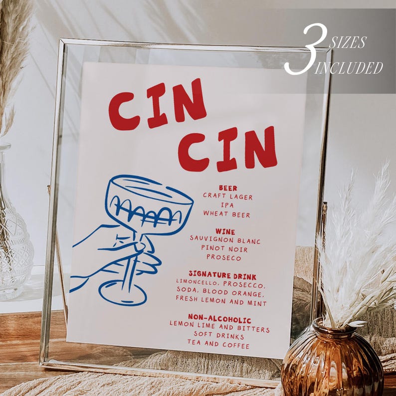 May include: A framed print with a red and blue design. The text "CIN CIN" is at the top, with a list of drinks below, including beer, wine, and non-alcoholic options. A hand holding a cocktail glass is illustrated in blue. The words "3 sizes included" are in the top right corner.