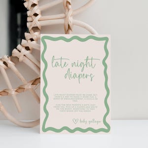 May include: A baby shower sign with the words "late night diapers" in a script font, framed by a wavy green border. The sign includes instructions and the name "baby gallager".