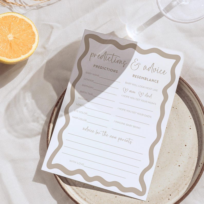 Boho wave baby shower prediction and advice for parents card gender neutral baby shower game design editable template laid on a simple plate with lemon slice and glass shadow over neutral linen background styled for modern shower decor printable card activity inviting guests to predict baby details and offer advice for the new parents