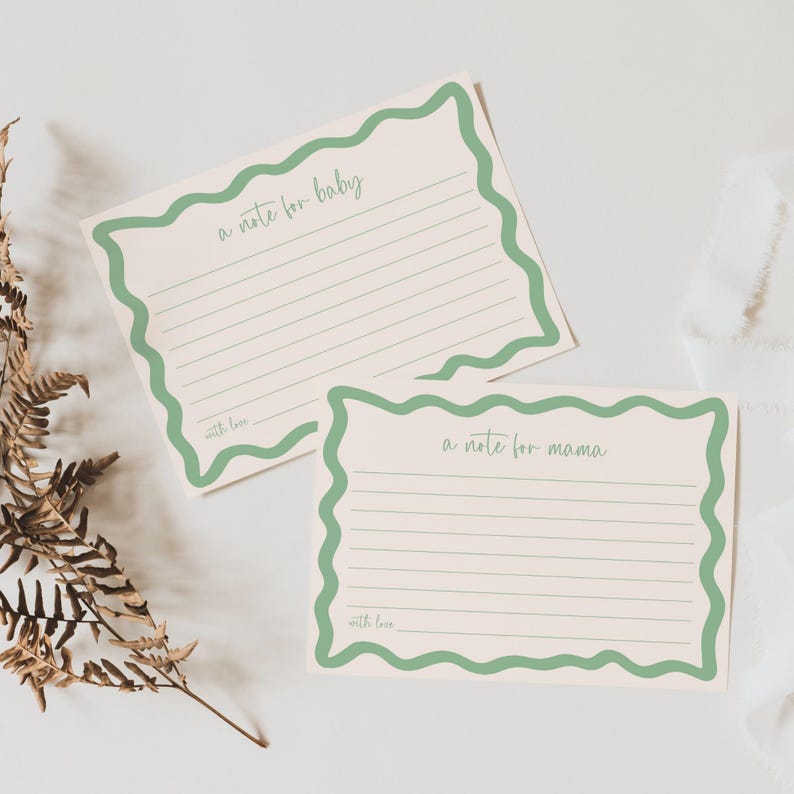 two blank green-bordered note cards with blank lines, placed on a white background.