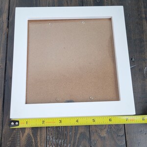 May include: White picture frame with a brown mat. The frame is 8 inches wide and 10 inches tall.