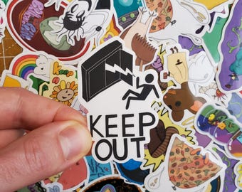 May include: A white sticker with a black silhouette of a door with a lightning bolt and a stick figure falling. The sticker says "KEEP OUT" in black letters.