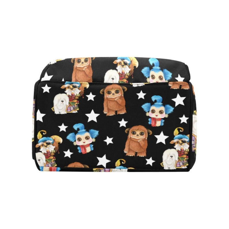 May include: Black canvas backpack with a repeating pattern of white stars, furry brown creatures, and blue creatures with white wings.