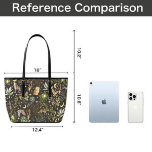 May include: Black tote bag with a forest-themed pattern featuring animals and plants. The bag is 16 inches wide, 12.4 inches tall, and has a handle. The bag's height is 10.2 inches. The bag is shown next to a tablet and a phone for size comparison.