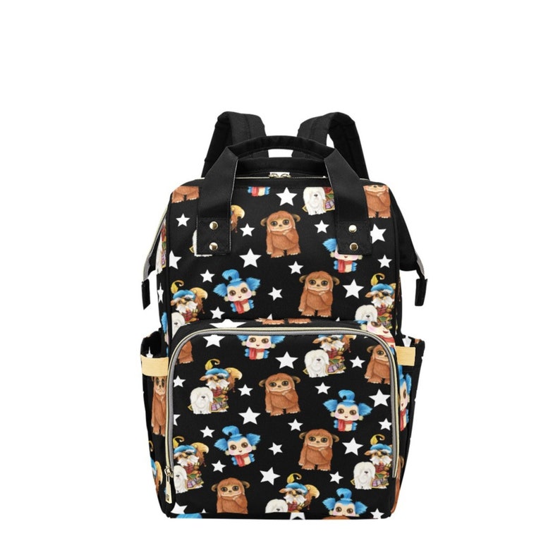 May include: Black diaper bag with a white star and cartoon character print. The bag has a large main compartment, two side pockets, and a front pocket.