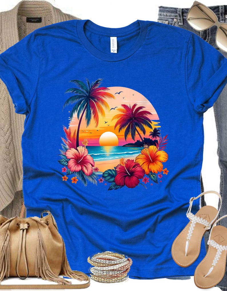 May include: A royal blue t-shirt with a colorful sunset scene featuring palm trees, a beach, and hibiscus flowers.
