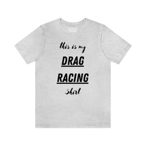 May include: A light gray t-shirt with black text that reads "This is my DRAG RACING Shirt".