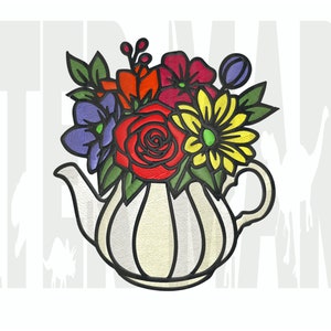 May include: A white teapot with a floral arrangement of red, yellow, purple, and green flowers. The teapot has a rounded body and a spout on the left side.