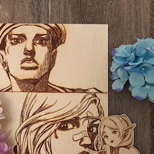 May include: Wooden art pieces featuring engraved portraits of anime characters. The artwork includes a portrait of a person wearing a hat, a portrait of a person with long hair, and a small figure pointing.
