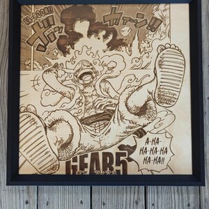 May include: Wooden framed artwork featuring a detailed wood-burned illustration of a manga character in a dynamic pose. The artwork includes Japanese text and sound effects, with the word "GEAR5" prominently displayed. The frame is black.