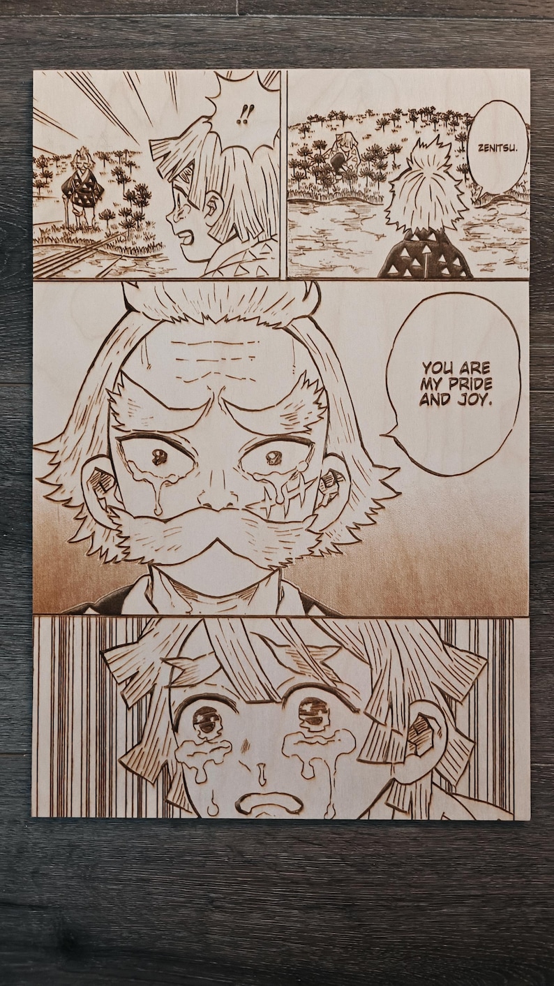 May include: Wooden artwork featuring panels from a manga. The panels depict characters with detailed line art, showcasing emotional expressions. Text includes "ZENITSU" and "YOU ARE MY PRIDE AND JOY." The artwork is on a light brown wooden surface.