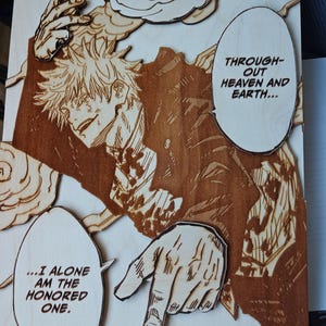 May include: Wooden artwork featuring a manga-style illustration of a character with spiky hair and speech bubbles. The artwork is in shades of brown and tan, with text that reads "...I ALONE AM THE HONORED ONE."