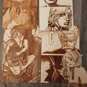 May include: A collection of wood-burned art pieces featuring anime and manga characters. The pieces include scenes from various series, with detailed illustrations and text. The art is displayed on wooden panels, showcasing the intricate burn designs.