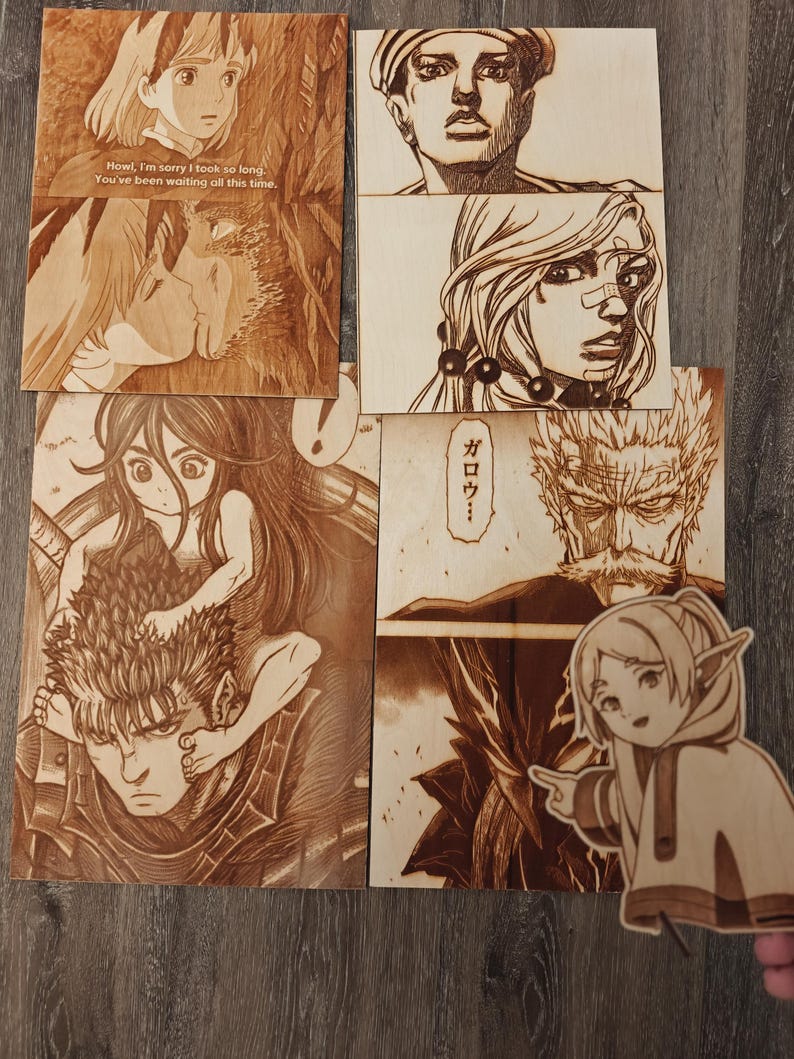 May include: A collection of wood-burned art pieces featuring anime and manga characters. The pieces include scenes from various series, with detailed illustrations and text. The art is displayed on wooden panels, showcasing the intricate burn designs.