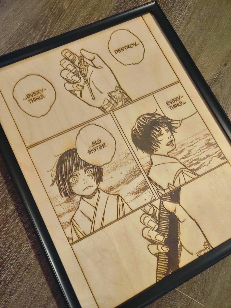 May include: Framed wooden artwork featuring a manga comic strip. The artwork is laser-etched with four panels, showcasing characters and speech bubbles with text. The frame is black.