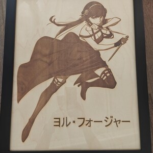 May include: Wooden framed artwork featuring a detailed laser-etched illustration of a female anime character in a dynamic pose. The artwork is in shades of brown and tan, with Japanese text at the bottom. The frame is black.