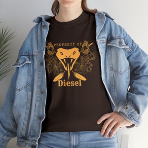 May include: A brown t-shirt with an orange snake head graphic and the text "PROPERTY OF Diesel" printed on the front.