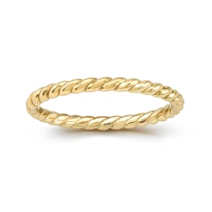 May include: A thin gold band ring with a twisted rope design.