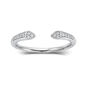 May include: A silver ring with two teardrop-shaped diamond accents. The ring is open on one side and has a delicate design.