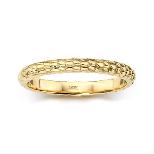 May include: A gold band ring with a textured, snake-like design. The ring is marked "14K" on the inside.