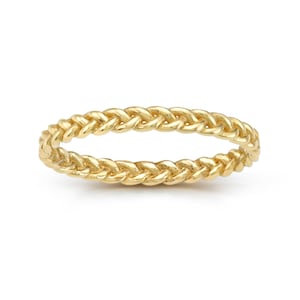 May include: A gold braided ring with a simple design.
