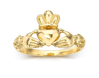 May include: A gold-colored Claddagh ring with a heart, two hands, and a crown on top.