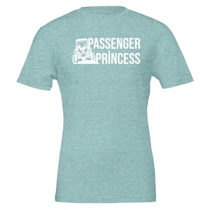 May include: A light blue t-shirt with a white graphic of a side-by-side vehicle and the text "Passenger Princess".